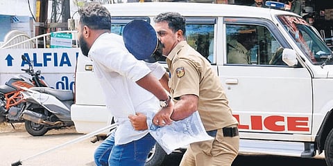 Police block a YC activist from barging into the office of Minister P Rajeeve in Kalamassery during a protest demanding the arrest of MCH superintendent | A Sanesh