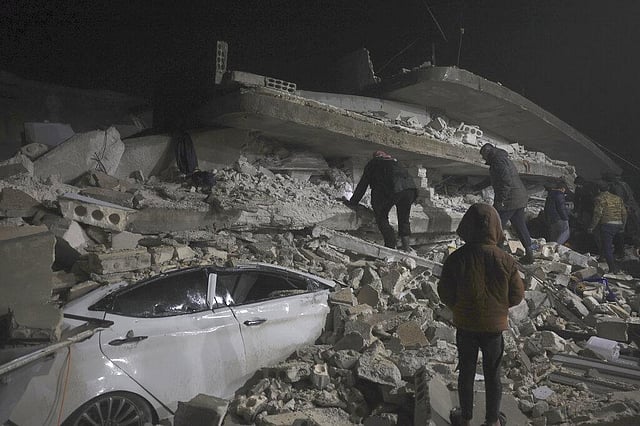 Syrian citizen search through the wreckage of a collapsed building, in Azmarin town, in Idlib province north Syria, Monday, Feb. 6, 2023. A powerful earthquake hit southeast Turkey and Syria early Monday, toppling buildings and sending panicked residents pouring outside on a cold winter night. (Photo | AP)