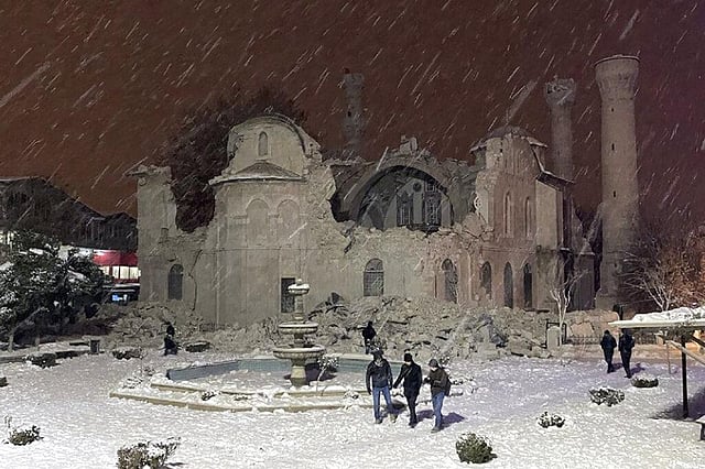 People walk next to a mosque destroyed by an earthquake in Malatya, Turkey, Monday, Feb. 6, 2023.  (Photo | AP)