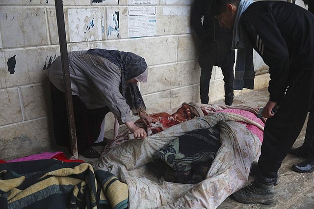 A woman tries to identify the bodies of earthquake victims recovered in Azmarin town,Idlib province, northern Syria, Monday, Feb. 6, 2023.  (Photo | AP)