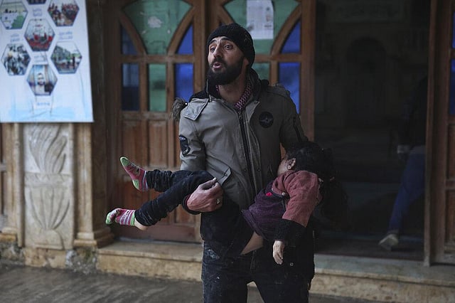 A Syrian man carries a dead young girl, in Azmarin town, in Idlib province north Syria, Monday, Feb. 6, 2023. A powerful earthquake hit southeast Turkey and Syria early Monday, toppling buildings and sending panicked residents pouring outside on a cold winter night.  (Photo | AP)