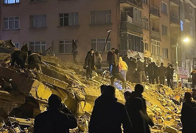 People try to reach trapped residents in a collapsed building in Pazarcik, in Kahramanmaras province, southern Turkey, early Monday, Feb. 6, 2023. (Photo | AP)