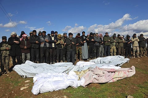 Mourners pray over coffins of family members who died in a devastating earthquake that rocked Syria and Turkey at a cemetery in the town of Jinderis, Syria, Tuesday, Feb. 7, 2023. (Photo | AP)