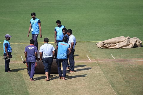 Members of ground staff use a roller on the pitch at the VCA Stadium in Nagpur on February 7, 2023, ahead of the first Test cricket match between India and Australia. (Photo | AFP)