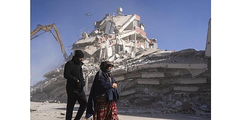 Local residents walk in front of a destroyed building in Nurdagi, southeastern Turkey, Thursday, Feb. 9, 2023. (Photo | AP)