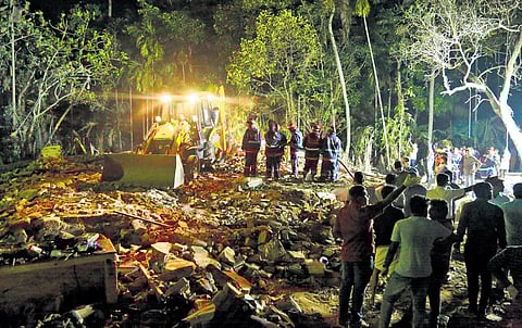 Fire and Rescue Services personnel searching the debris of the building that was gutted in the blast