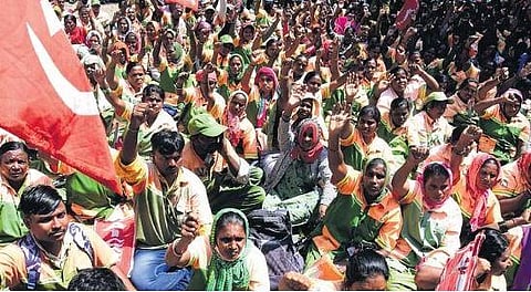 Pourakarmikas sit in protest in front of the BBMP head office in Bengaluru on Tuesday | Shashidhar Byrappa