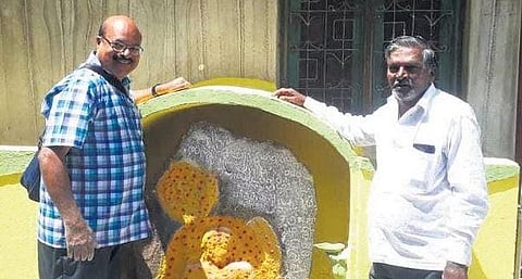 BMTC bus driver R Dhanapal (left) and his friend, Sathish Kumar, with the stone inscription at Jogupalya in Halasuru.