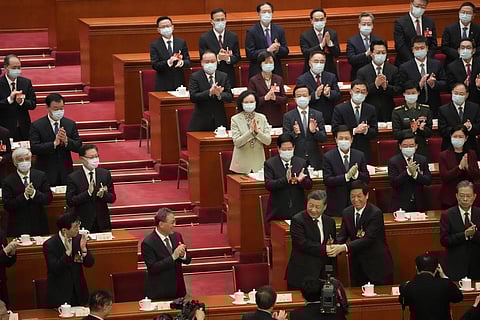 Chinese President Xi Jinping is congratulated by Li Zhanshu after he is unanimously elected as President during a session of China's National People's Congress. (Photo | AP)