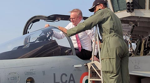 Australian Prime Minister Anthony Albanese climbs inside the cockpit of LCA onboard INS Vikrant, in Mumbai on Thursday. (Photo | ANI)
