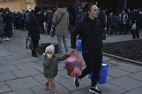 People receive food at a humanitarian aid distribution spot in Zaporizhzhia, Ukraine, Thursday, March 9, 2023. (Photo | AP)