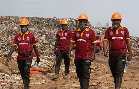 Civil Defence volunteers engaged in firefighting operations at Brahmapuram on Thursday. (Photo | T P Sooraj, EPS)  ​