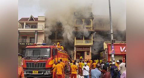 Fire services personnel trying to douse the blaze inside the market complex. (Photo | Ranjan Ganguly)
