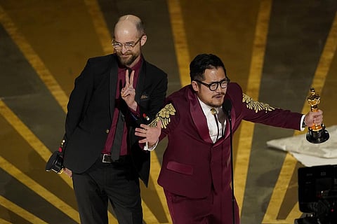 Daniel Scheinert, left, and Daniel Kwan accept the award for best original screenplay for 'Everything Everywhere All at Once' at the Oscars. (Photo | AP)
