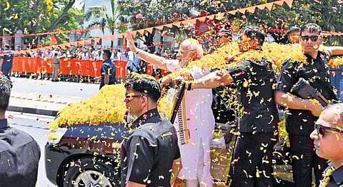Mandya maths: PM Narendra Modi showered with petals during a roadshow before the inauguration of the expressway in Mandya on Sunday | Udayashankar S