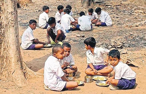 Students of Government UP School, Chandragiri having meals under the sun | Express