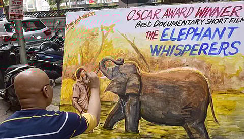 Gurukul art student makes painting to congratulate The Elephant Whisperers for winning Oscar award, at Lalbaug in Mumbai. (Photo | AP)