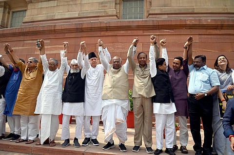 Feb 16, 2O23: Opposition leaders form a human chain in the Parliament House premises demanding a probe by a joint parliamentary committee into alleged irregularities in the Adani Group. (Photo | PTI)