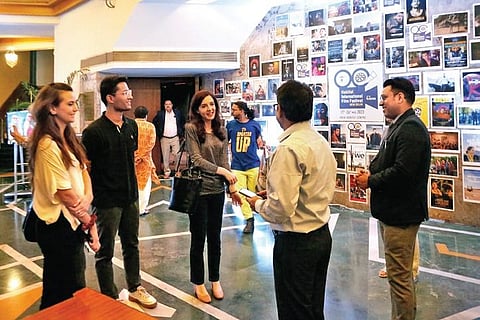 Attendees at Habitat International Film Festival; (left) viewer at the VR Section