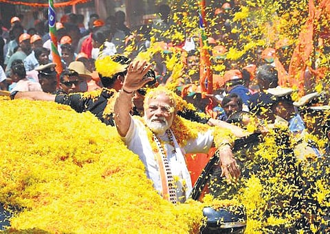 Prime Minister Narendra Modi takes part in a roadshow in Mandya | Express
