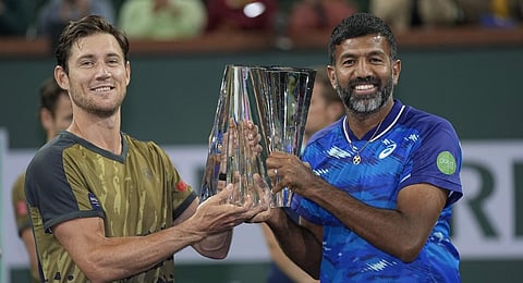 Matthew Ebden, of Australia, left, and teammate Rohan Bopanna, of India, hold up the men's doubles winner's trophy at the BNP Paribas Open tennis tournament.(Photo |AP)