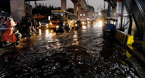 Motorists driving on a waterlogged road in Hyderabad on Saturday