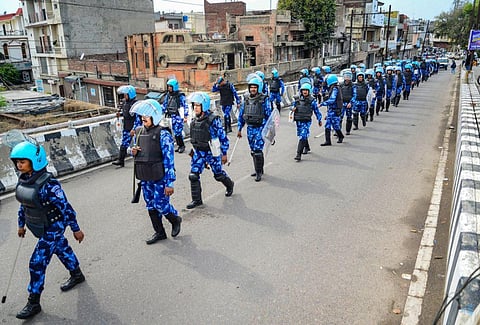 Rapid Action Force (RAF) personnel flag march amid a crackdown against 'Waris Punjab De' chief Amritpal Singh and his aides, in Jalandhar, March. 20, 2023. (Photo | PTI)