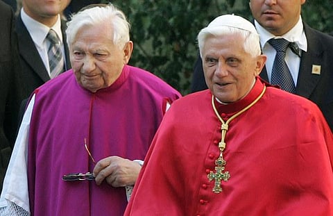 Late Pope Benedict XVI, right, walks with his brother priest Georg Ratzinger in Regensburg, southern Germany. (File photo | AP)