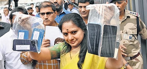 BRS MLC K Kavitha shows her old phones to be submitted to the ED, outside the agency’s headquarters in New Delhi on Tuesday | Shekhar Yadav