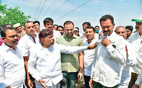TS Planning Board vice-chairman B Vinod Kumar consoles a farmer whose maize crops were damaged in Ramadugu mandal of Karimnagar district on Tuesday