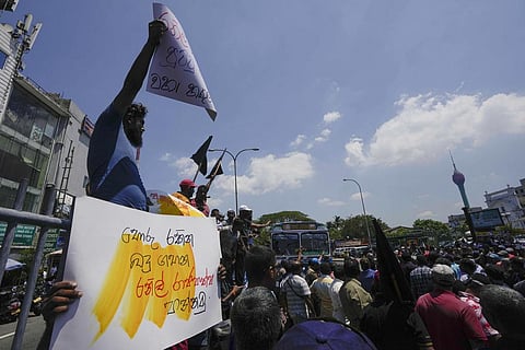 Sri Lankans shout slogans during a protest against the government increasing income tax to manage day to day expenses amid an  economic crisis in Colombo. (Photo | AP)