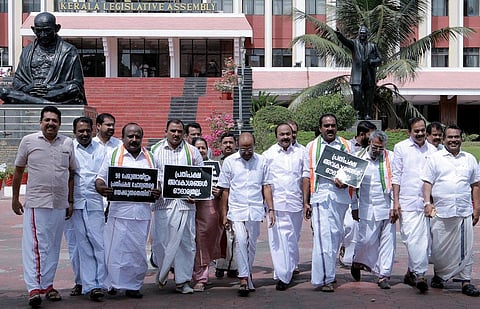 Opposition MLAs coming out of the assembly after protesting against the Speaker and the ruling front on Tuesday. (Photo | Express)