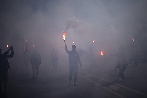 Protesters march with flares during a demonstration in Marseille, southern France on Tuesday, March 28, 2023. (Photo | AP)