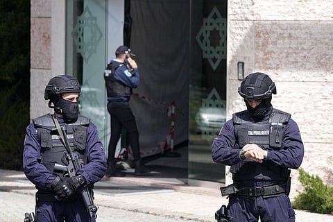 Police officers stand at the entrance of an Ismaili Muslim centre in Lisbon, Portugal on Tuesday, March 28, 2023. (Photo | AP)