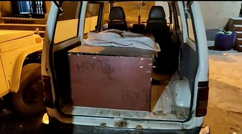 Smugglers were caught transporting liquor bottles in a coffin stored in an ambulance. (Photo | Twitter)