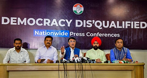 Congress' Pawan Khera (C) along with Atul Londhe (L) and Charan Singh Sapra addresses a press conference on the disqualification of Rahul Gandhi from Lok Sabha, in Mumbai. (Photo | PTI)