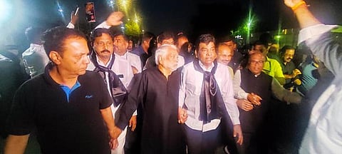 BRS MPs, wearing black clothes, take part in a rally against the disqualification of Rahul Gandhi, in Delhi on Tuesday