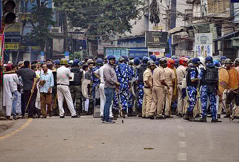 Security personnel cordon off an area after clashes broke out between two groups during a 'Ram Navami' procession on Thursday, at Kajipara in Howrah. (Photo | PTI)
