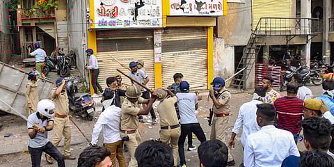 Police try to control mob after incidents of stone pelting on a 'Rm Navmi'procession, in Vadodara. (Photo | PTI)