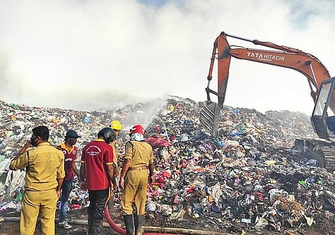 Fire and Rescue Services personnel dousing the fire at Brahmapuram waste treatment plant on Friday | Express