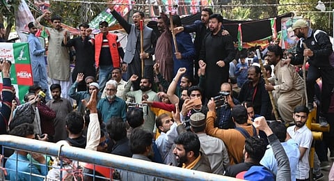 Supporters of former Pakistan's prime minister Imran Khan chant slogans outside his house in Lahore on March 5, 2023.(Photo | AFP)