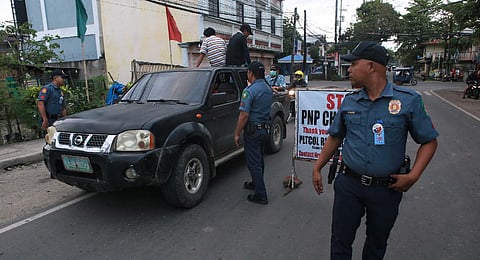 Policemen man at checkpoint in the Philippine Province of Negros Oriental on March 4, hours after the provincial governor Roel Degamo and five others were killed by unknown gunmen. (Photo | AFP)