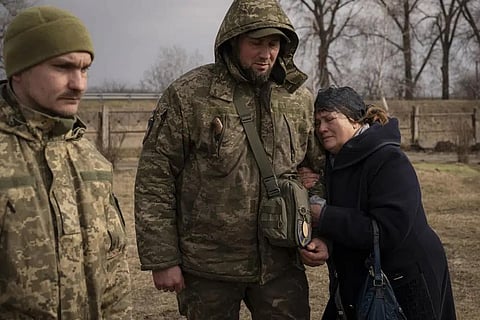 Tetiana Hurieieva, the mother of Volodymyr Hurieiev, a Ukrainian soldier killed in the Bakhmut area, cries after his the funeral in Boryspil, Ukraine, March 4, 2023. (Photo | AP)