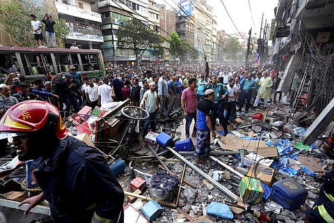 Onlookers gather outside the site of an explosion, in Dhaka, Bangladesh, Tuesday, March 7, 2023. (Photo | AP)