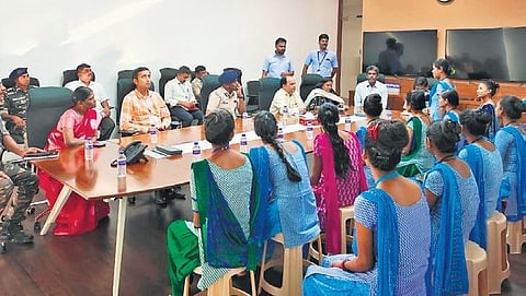 Jharkhand officials interacting with migrant workers of a spinning mill in Tiruppur district on Monday. (Photo | Express)