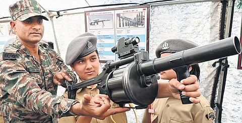 A girl cadet checks out a weapon at Rashtriya Military School in Bengaluru on Monday | Shashidhar Byrappa