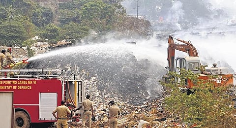 Fire and Rescue Services personnel try to douse the fire at Brahmapuram waste treatment plant in Kochi | Express 