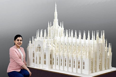 Pune-based royal icing artist Prachi Dhabal Deb, poses with her confectionery creation - a 100kg replica of Italy's Milan cathedral. (Photo | PTI)