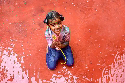 Holi was celebrated across India with traditional fervour and gaiety on Wednesday as people smeared 'gulal' (colour powder), threw balloons filled with colours on each other and exchanged sweets. Holi, the festival which marks the last full-moon day of the lunar month, celebrates the beginning of spring and the victory of good over evil. (Photo | Ashwin Prasath, EPS)