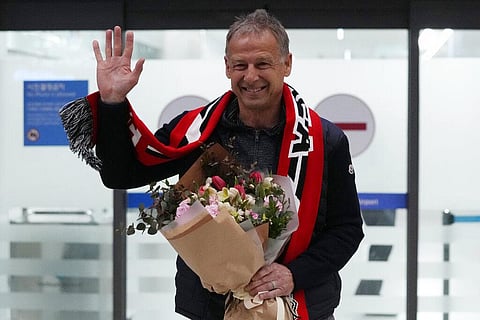 South Korea's new national soccer team head coach Jurgen Klinsmann waves upon his arrival at the Incheon International Airport in Incheron, South Korea, Wednesday, March 8, 2023. (Photo | AP)